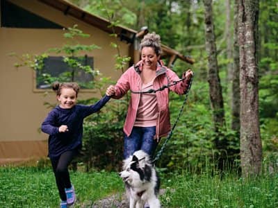 Mom and daughter running with dog